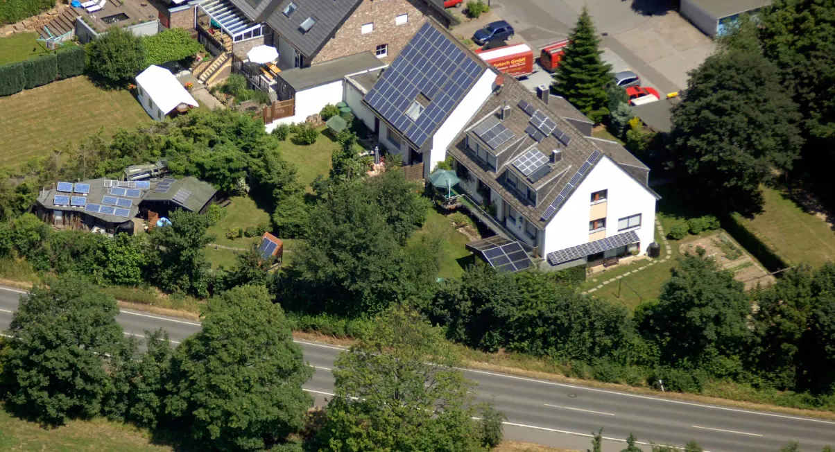Luftbild einer Wohnsiedlung mit Photovoltaik-Dächern